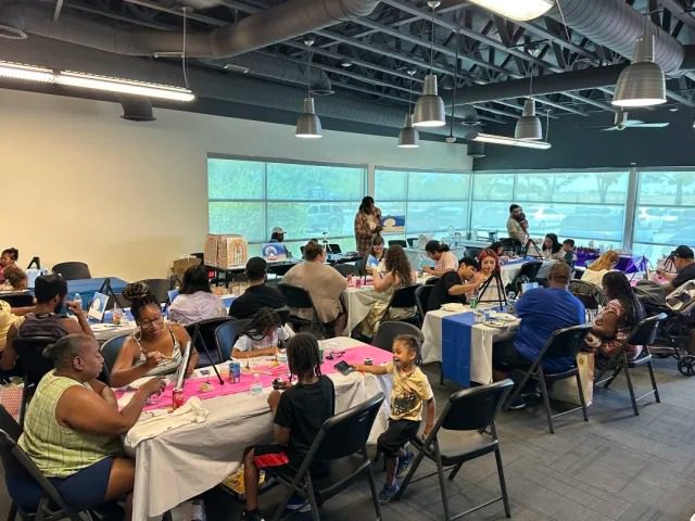 Families enjoying a painting workshop together
