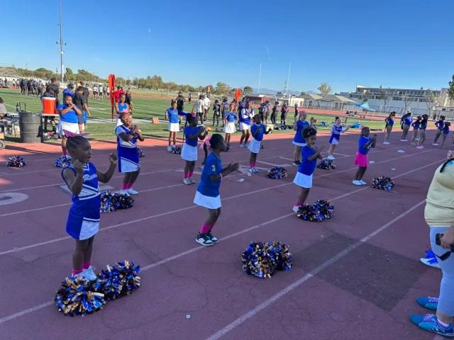 Cheer squad practicing routine outdoors