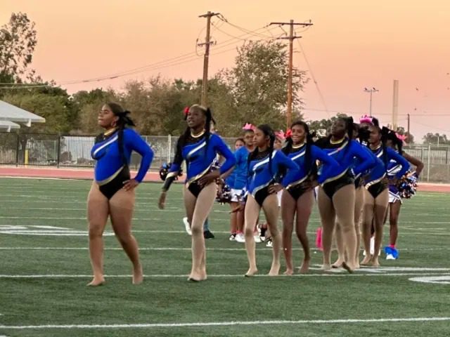 Cheerleaders lined up on football field