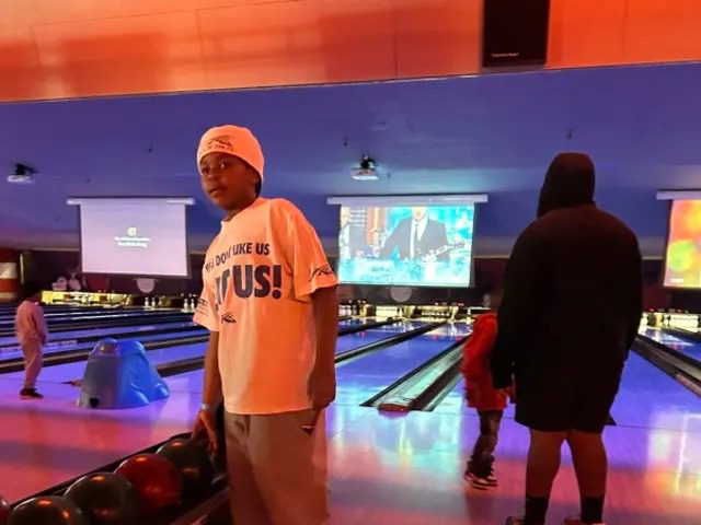 Group enjoying bowling under neon lights