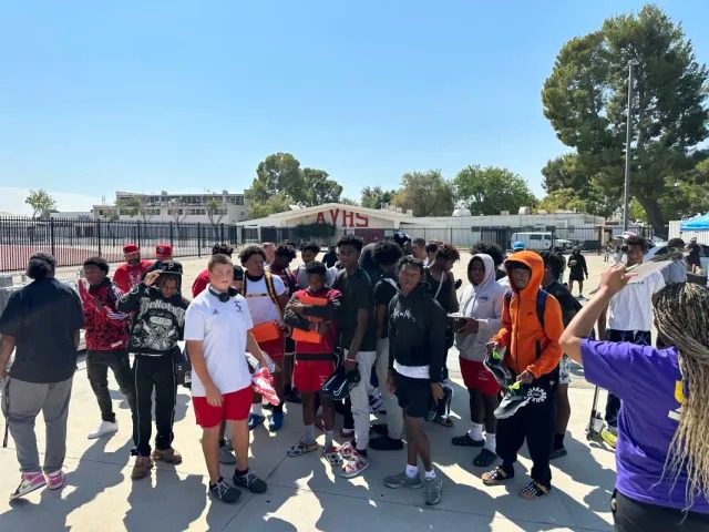 Outdoor student gathering at school entrance