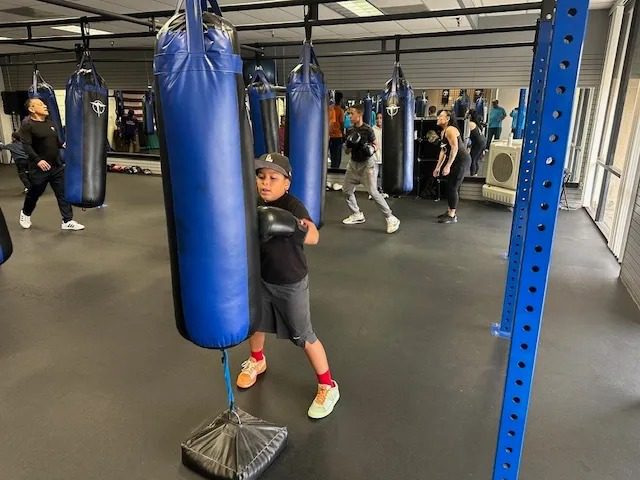 Kids practicing boxing skills in gym